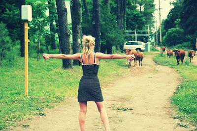 Woman standing on grassy field