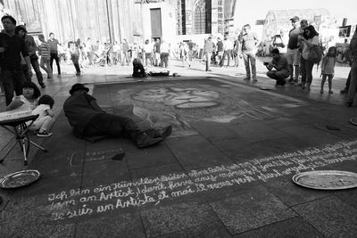 Rear view of man sitting on city street