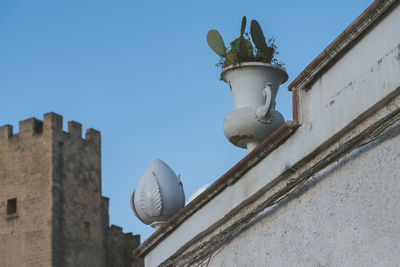 Low angle view of street light against building