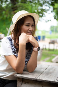 Portrait of a smiling young woman sitting outdoors