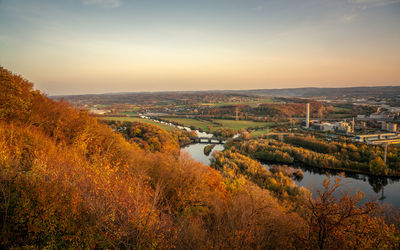 Scenic view of river against sky during autumn