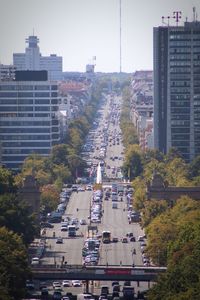 Cars on street amidst buildings in city against clear sky