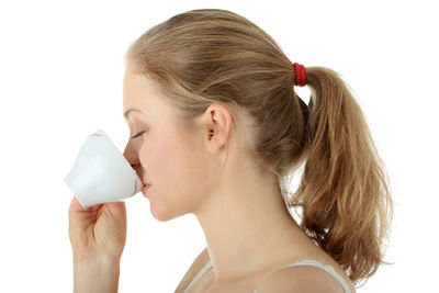 Close-up portrait of a woman drinking glass
