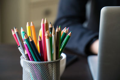 Close-up of multi colored pencils in desk organizer