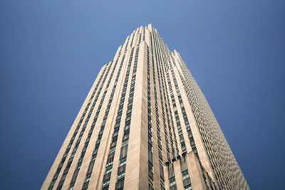 Low angle view of skyscraper against clear blue sky