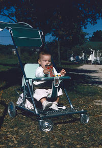 Full length of boy sitting in park