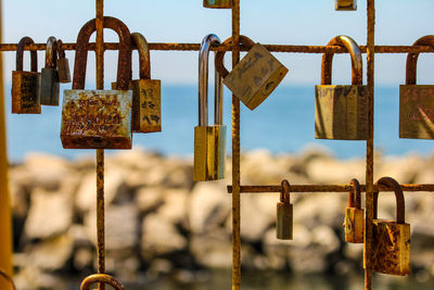 Close-up of padlocks hanging on railing