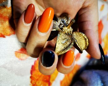 Cropped hand of woman holding jewelry