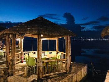 Built structure on beach against sky at night