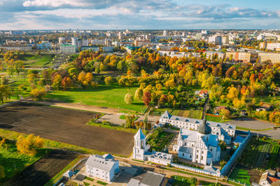 High angle view of trees and buildings in city