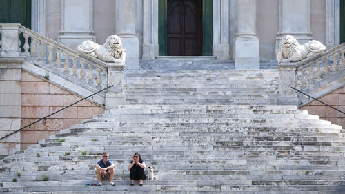 People sitting on staircase of building