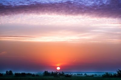 Scenic view of silhouette landscape against romantic sky at sunset