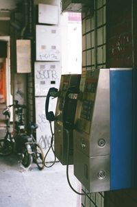 Close-up of telephone booth on wall