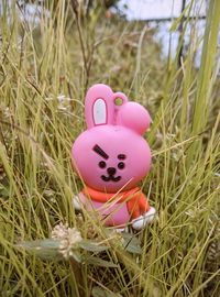 Close-up of pink stuffed toy on field