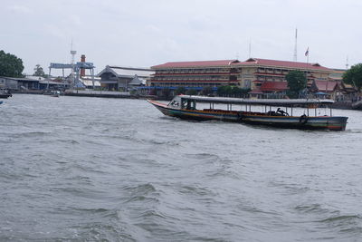 Boats in river with buildings in background