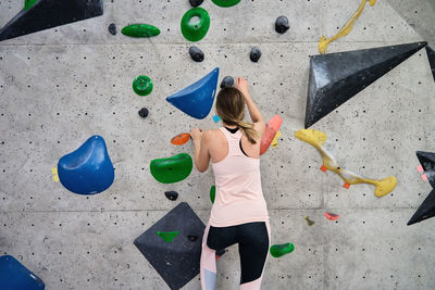 Woman training at bouldering gym. active recreation, sports exercises