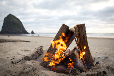 Bonfire on beach against sky