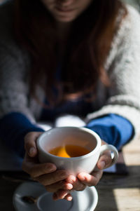 Close-up of woman holding tea cup