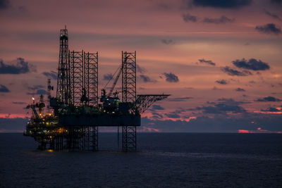 Silhoutte of the oil rig platform in sunset