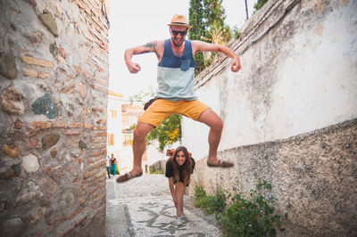 Full length of woman standing by railing