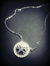 Close-up of necklace on white background