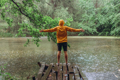 Full length of child standing on lake during rainy season