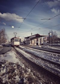 Railroad tracks against sky during winter