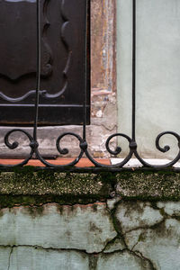 Close-up of metal gate against building