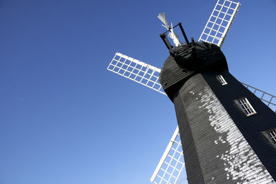 Low angle view of traditional windmill against clear sky