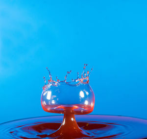 Close-up of water splashing against blue background