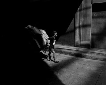 Man with dog at night in city