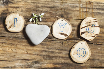 Directly above shot of wood craft and rock on table