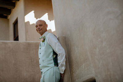 Low angle view of man standing against wall