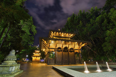 Illuminated building against sky at night