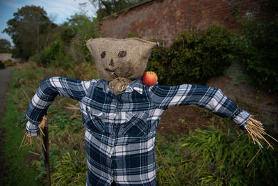 Midsection of person standing by plants against trees