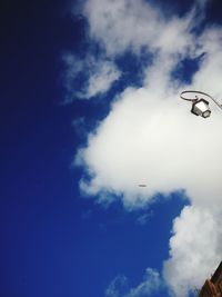 Low angle view of kite flying against blue sky