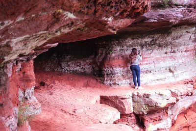 Rear view of woman standing on rock