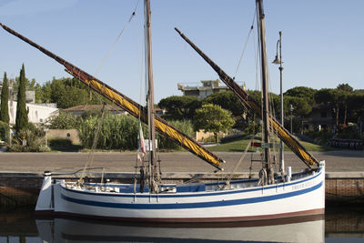 Sailboats moored at port against sky