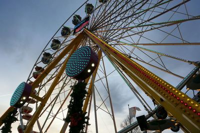 Low angle view of ferris wheel against sky