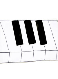 Close-up of piano keys over white background