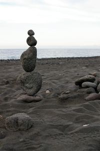 Pebbles on beach against sea