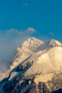 Scenic view of snowcapped mountains against clear sky