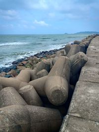 Pebbles on beach against sky