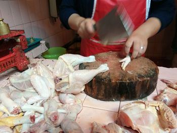 Midsection of man preparing food at market stall