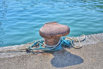 High angle view of rope tied on metal