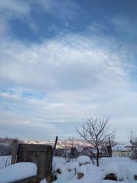 Snow covered field against sky