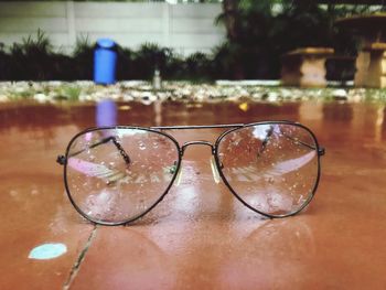 Close-up of sunglasses on swimming pool