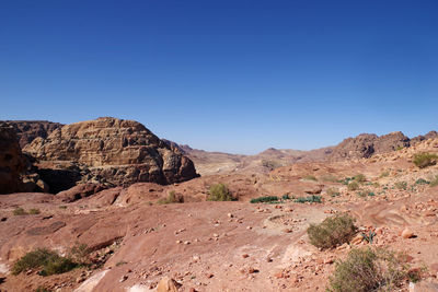 Scenic view of rocky mountains against clear blue sky