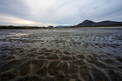 Wetland and mountains in cloudy evening