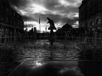 Silhouette of woman against cloudy sky